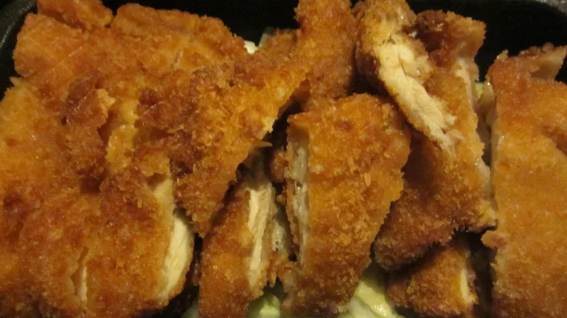 Sliced chicken katsu with a golden crumb coating.