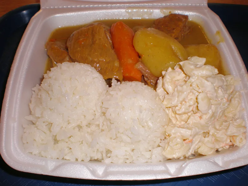 Beef curry plate lunch with white rice and macaroni salad.